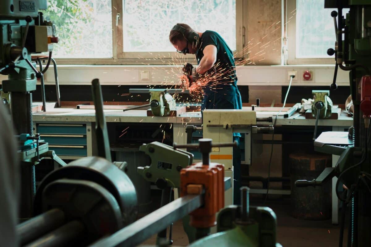 selective focus photography of man using angle grinder